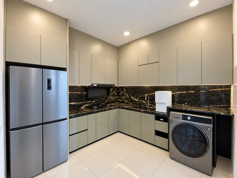 L-Shaped Kitchen Cabinets With Dark Gold-Veined Backsplash And Fitted Appliances.