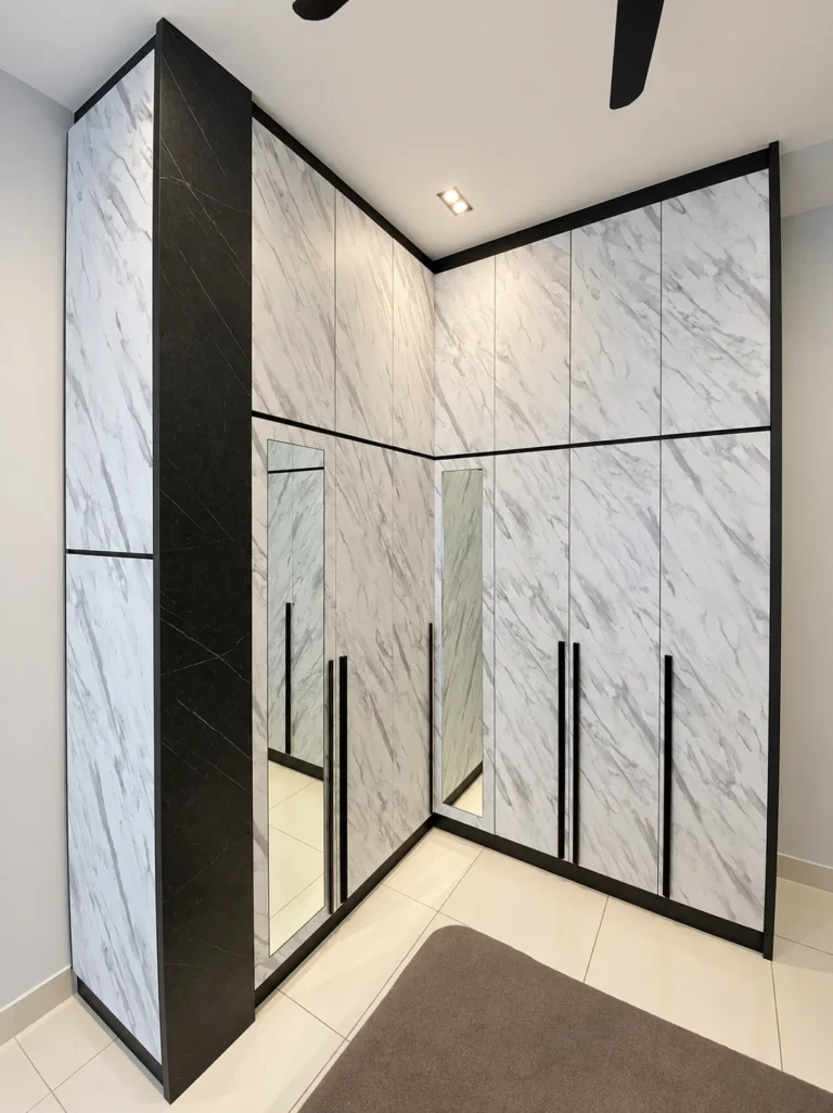 L-Shaped Marble-Pattern Wardrobe With Black Trim And Mirrored Panels.